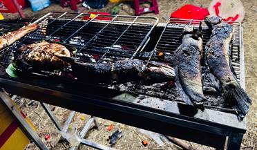 A fish on a grill  Description automatically generated